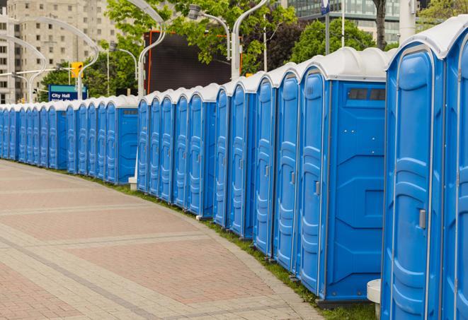 a line of portable restrooms at an outdoor wedding, catering to guests with style and comfort in Bellaire